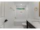 Bright bathroom featuring white tile, gold fixtures, and a shower-tub combo at 702 Sanderson Dr, Durham, NC 27704