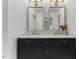Bathroom featuring a black vanity with marble countertop, dual mirrors, and modern fixtures at 702 Sanderson Dr, Durham, NC 27704
