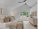Bright bedroom with neutral tones, large window, and decorative wall art at 702 Sanderson Dr, Durham, NC 27704