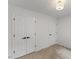 The bedroom features neutral carpet, standard closet, and simple overhead lighting at 702 Sanderson Dr, Durham, NC 27704