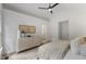 Calm bedroom with vaulted ceilings, dresser, and a door leading to another room at 702 Sanderson Dr, Durham, NC 27704