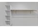 A closet features built in shelving and hanging rod for organization at 702 Sanderson Dr, Durham, NC 27704