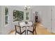 Sunlit dining area with views to fireplace through doorway and natural light from the many windows at 702 Sanderson Dr, Durham, NC 27704