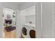 Laundry room features washer and dryer with a view into the living room and fireplace at 702 Sanderson Dr, Durham, NC 27704