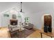 Bright living room with vaulted ceilings, fireplace, hardwood floors, stylish decor, and comfortable neutral furniture at 702 Sanderson Dr, Durham, NC 27704