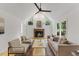 Bright living room featuring hardwood floors, fireplace with decor, comfortable neutral furniture, and vaulted ceilings at 702 Sanderson Dr, Durham, NC 27704