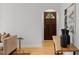 Living room features hardwood floors, decorative wall art, and a wooden front door at 702 Sanderson Dr, Durham, NC 27704