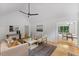 Inviting living room showcasing vaulted ceilings, hardwood floors, neutral color scheme, and view into dining room at 702 Sanderson Dr, Durham, NC 27704