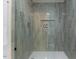 Modern shower with sleek tile, glass door, and niche for toiletries at 702 Sanderson Dr, Durham, NC 27704
