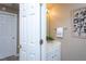 Cozy half bath with modern vanity, decorative mirror, and warm lighting at 7244 Galon Glen Rd, Raleigh, NC 27613