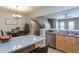 View of the kitchen island and dining room with living area in the background at 7244 Galon Glen Rd, Raleigh, NC 27613