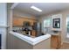 Bright kitchen with stainless appliances, light wood cabinets, and breakfast bar seating at 7244 Galon Glen Rd, Raleigh, NC 27613