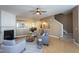 Open-concept living room with fireplace, ceiling fan, and view into dining area at 7244 Galon Glen Rd, Raleigh, NC 27613