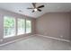 Spacious primary bedroom offers soft carpeting, fresh neutral paint, and a lighted ceiling fan for maximum comfort at 7244 Galon Glen Rd, Raleigh, NC 27613