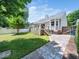 Backyard showing the patio, lawn, and backyard of the home that is surrounded by white fencing, and a partial view of the home at 8312 Bellingham Cir, Raleigh, NC 27615