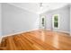 Spacious bedroom with two windows for natural light and hardwood floors at 8312 Bellingham Cir, Raleigh, NC 27615