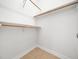 A closet featuring wooden shelving and tile flooring at 8312 Bellingham Cir, Raleigh, NC 27615