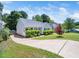 Exterior view of home with a well-manicured lawn, driveway, and tastefully trimmed bushes at 8312 Bellingham Cir, Raleigh, NC 27615