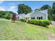Exterior view of home with a well-manicured lawn, driveway, and tastefully trimmed bushes at 8312 Bellingham Cir, Raleigh, NC 27615