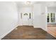Inviting foyer with wood-look tile flooring, a decorative front door with sidelights, and lots of natural light at 8312 Bellingham Cir, Raleigh, NC 27615