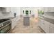 Open-concept kitchen with stainless steel appliances, a center island and lots of natural light at 8312 Bellingham Cir, Raleigh, NC 27615