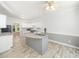 Stylish kitchen with white cabinets, stainless steel appliances, granite countertops, and wood-look tile flooring at 8312 Bellingham Cir, Raleigh, NC 27615