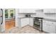 Close-up of a modern kitchen featuring stainless steel appliances, granite countertops and subway tile backsplash at 8312 Bellingham Cir, Raleigh, NC 27615