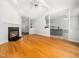 Bright living room featuring hardwood floors, a fireplace, and an open floor plan with views of the kitchen at 8312 Bellingham Cir, Raleigh, NC 27615