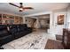 Spacious finished basement with a large black leather couch and built-in bookcase for versatile living space at 9200 Lake Carol Dr, Zebulon, NC 27597
