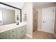 Bathroom featuring a double vanity, large mirror, and glass-enclosed shower for a modern and functional design at 9200 Lake Carol Dr, Zebulon, NC 27597