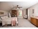 Charming bedroom featuring a cozy bed, built-in bookcase, and natural light from the windows at 9200 Lake Carol Dr, Zebulon, NC 27597