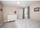 Comfortable bedroom with neutral paint, carpet, white dresser, and window with grey curtains at 9200 Lake Carol Dr, Zebulon, NC 27597