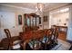 Formal dining room featuring a large table with seating for ten, chandelier and a china cabinet at 9200 Lake Carol Dr, Zebulon, NC 27597