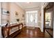 Bright foyer with hardwood floors, decorative console table, and a welcoming atmosphere at 9200 Lake Carol Dr, Zebulon, NC 27597