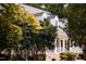 Charming two-story home with a brick foundation, white siding, front porch, and mature landscaping at 9200 Lake Carol Dr, Zebulon, NC 27597