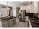 Bright kitchen featuring white cabinetry, stainless steel appliances and an island at 9200 Lake Carol Dr, Zebulon, NC 27597
