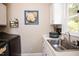 Functional laundry room area with sink, white cabinets, and window providing natural light at 9200 Lake Carol Dr, Zebulon, NC 27597