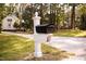 Quaint black mailbox on a white decorative post, adding to the home's curb appeal at 9200 Lake Carol Dr, Zebulon, NC 27597
