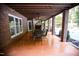 Covered patio featuring brick pillars, ceiling fan, and outdoor dining area at 9200 Lake Carol Dr, Zebulon, NC 27597