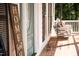 Front porch featuring a blue door and a swing with a bench at 9200 Lake Carol Dr, Zebulon, NC 27597