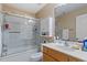 Bathroom with a glass-enclosed tub and shower combination, and a wood vanity with white sink at 933 Richland Ridge Dr, Wake Forest, NC 27587