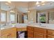Bathroom featuring double vanities, with a large framed mirror, and a walk-in shower at 933 Richland Ridge Dr, Wake Forest, NC 27587
