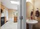 Bathroom with a pedestal sink and a view into the kitchen at 933 Richland Ridge Dr, Wake Forest, NC 27587