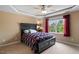 Bedroom features a decorative ceiling, neutral carpet, a window and a dark wood bed at 933 Richland Ridge Dr, Wake Forest, NC 27587