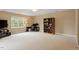Spacious bedroom with neutral carpet, a ceiling fan, large windows, and a bookcase at 933 Richland Ridge Dr, Wake Forest, NC 27587