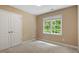 Neutral bedroom featuring a large window and closet with double doors at 933 Richland Ridge Dr, Wake Forest, NC 27587