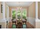 Traditional dining room with wood floors, wainscoting, and windows overlooking the backyard at 933 Richland Ridge Dr, Wake Forest, NC 27587