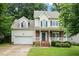 Charming two-story home featuring a well-manicured front yard and an attached two-car garage at 933 Richland Ridge Dr, Wake Forest, NC 27587