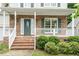 Welcoming front porch with brick accents, white railings, and a decorative front door at 933 Richland Ridge Dr, Wake Forest, NC 27587