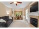Inviting living room with neutral tones, a cozy fireplace, and an open view into the dining area at 933 Richland Ridge Dr, Wake Forest, NC 27587